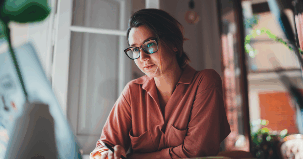 Off-duty nurse on laptop doing interview research