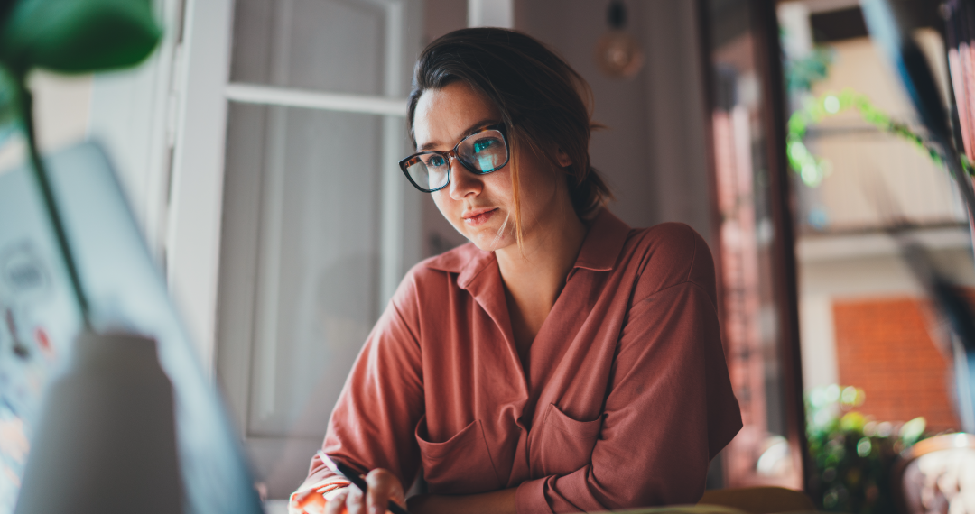 Off-duty nurse on laptop doing interview research