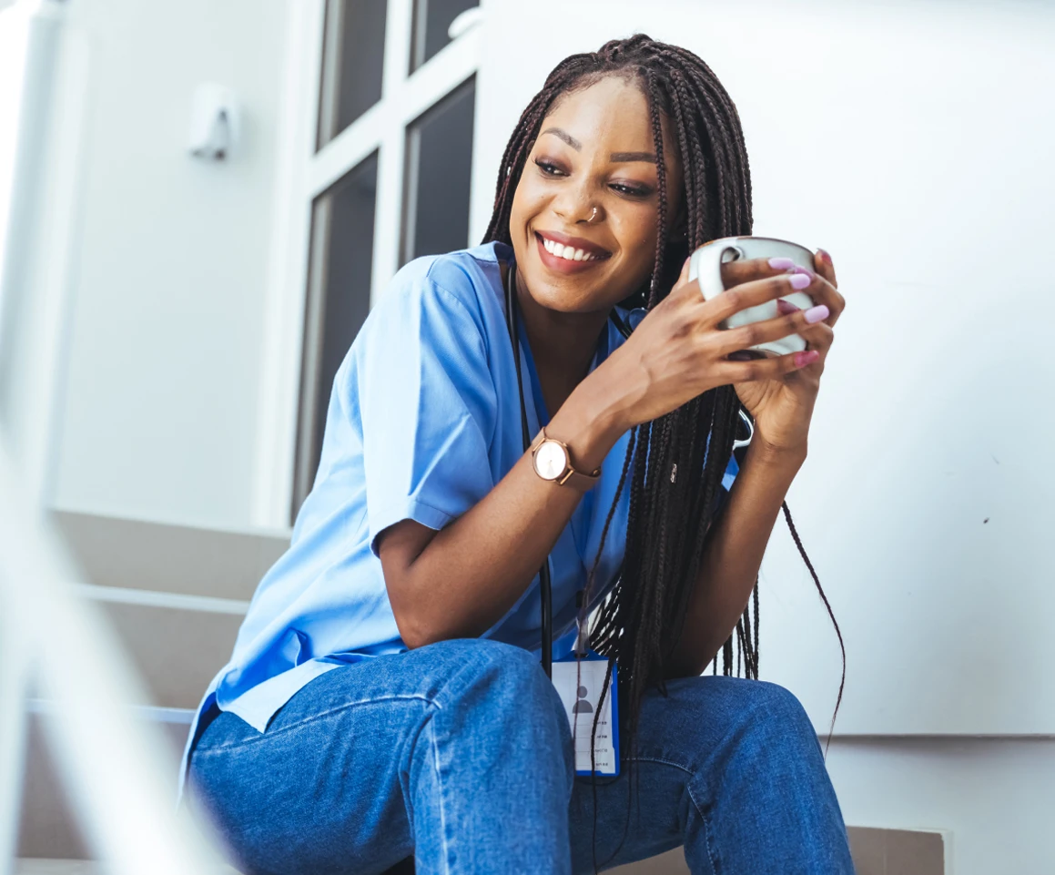Nurse having coffee on step